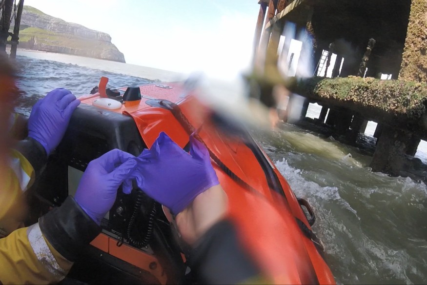 Crew braves rough seas to rescue person clinging to Pier